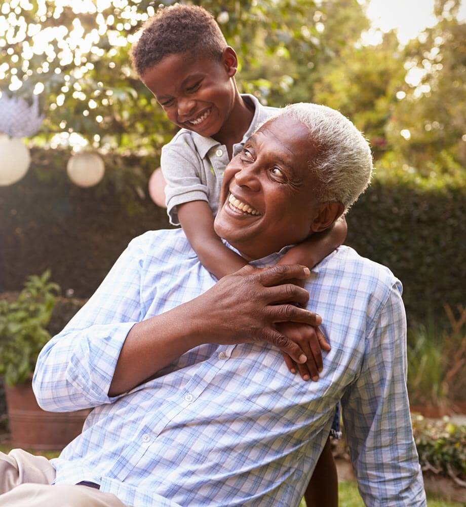 Grandfather playing outside with grandson