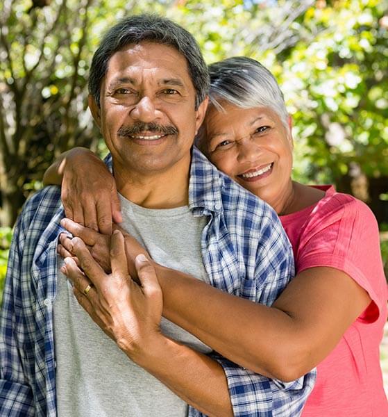 Woman with arms around man