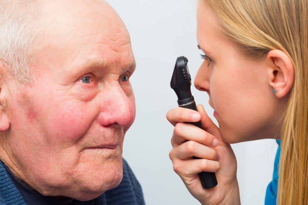 Older man having his eyes examined