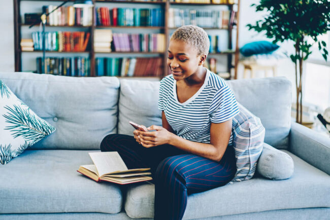 young woman on her phone on the couch