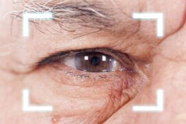 Close-up of Old Man's eye. High Technologies in the future