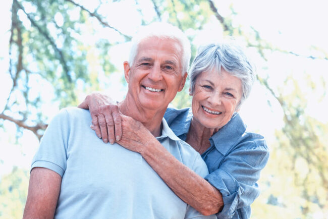 senior couple smiling in the park