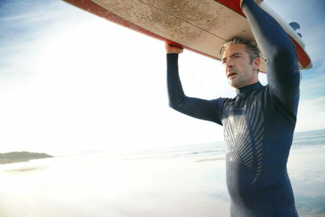 middle-aged man with surfboard