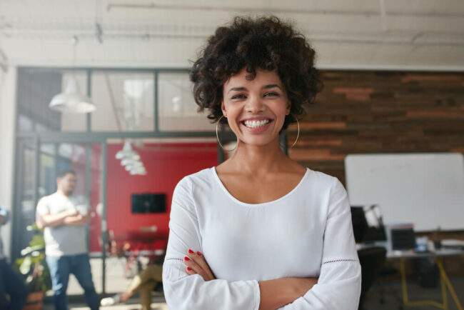 Young woman with arms crossed smiling