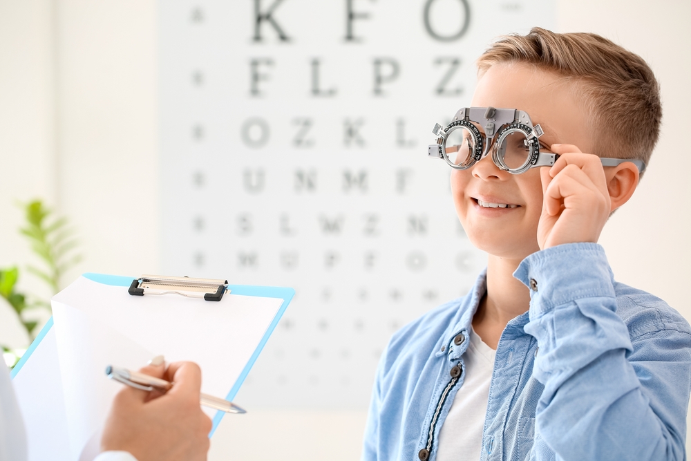 boy at eye exam smiling